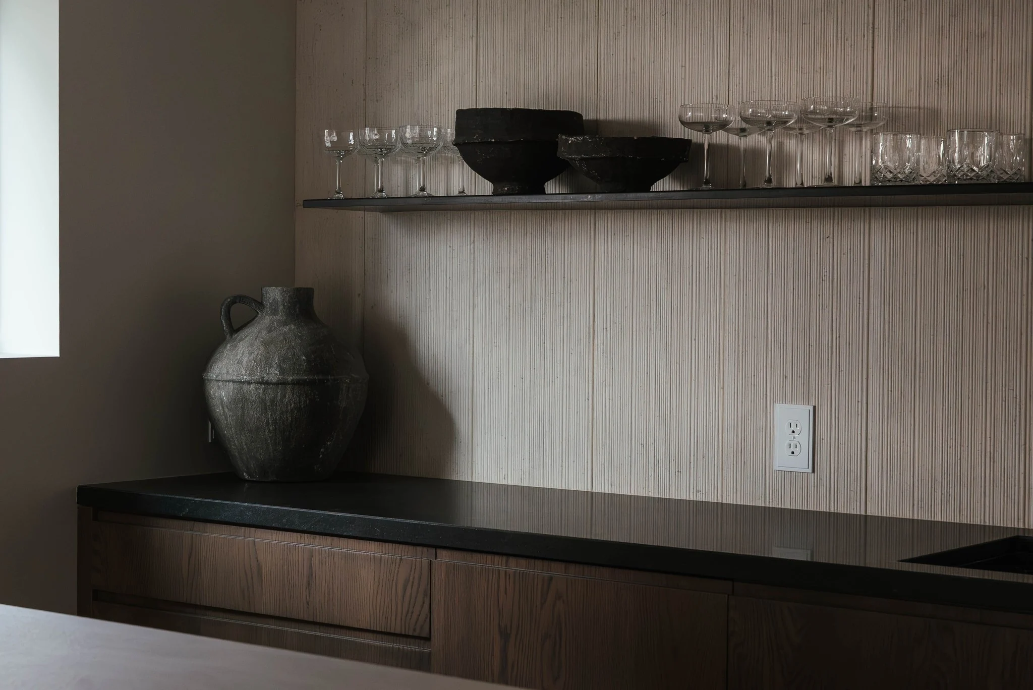 Oak bar cabinetry and floating shelves